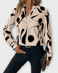 Elegant long-sleeved blouse with a pointed neckline