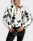 Elegant long-sleeved blouse with a pointed neckline